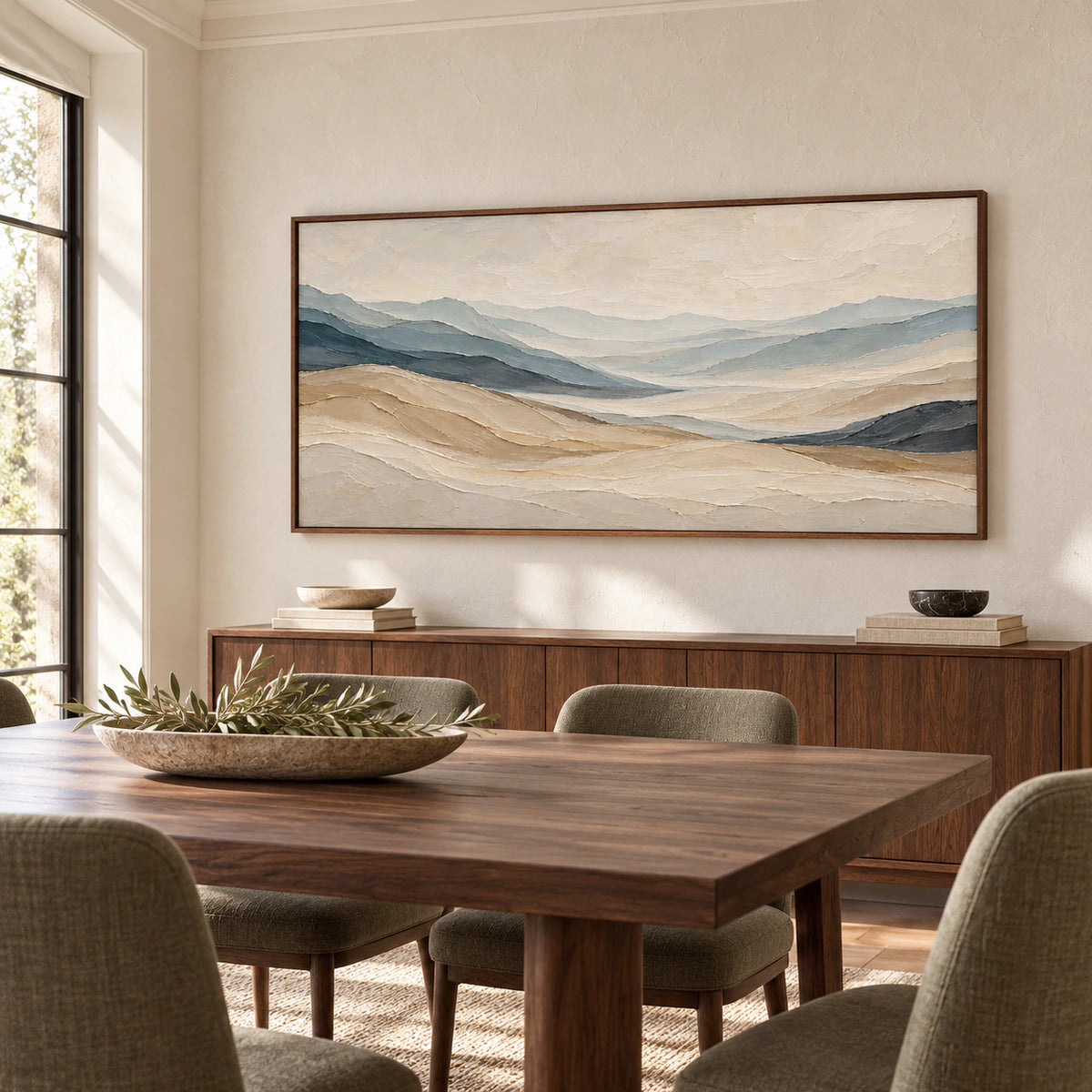 Ochre-Traverse on a warm white dining room wall above a dark walnut table with olive-gray upholstered chairs, viewed from the right beside a tall window.