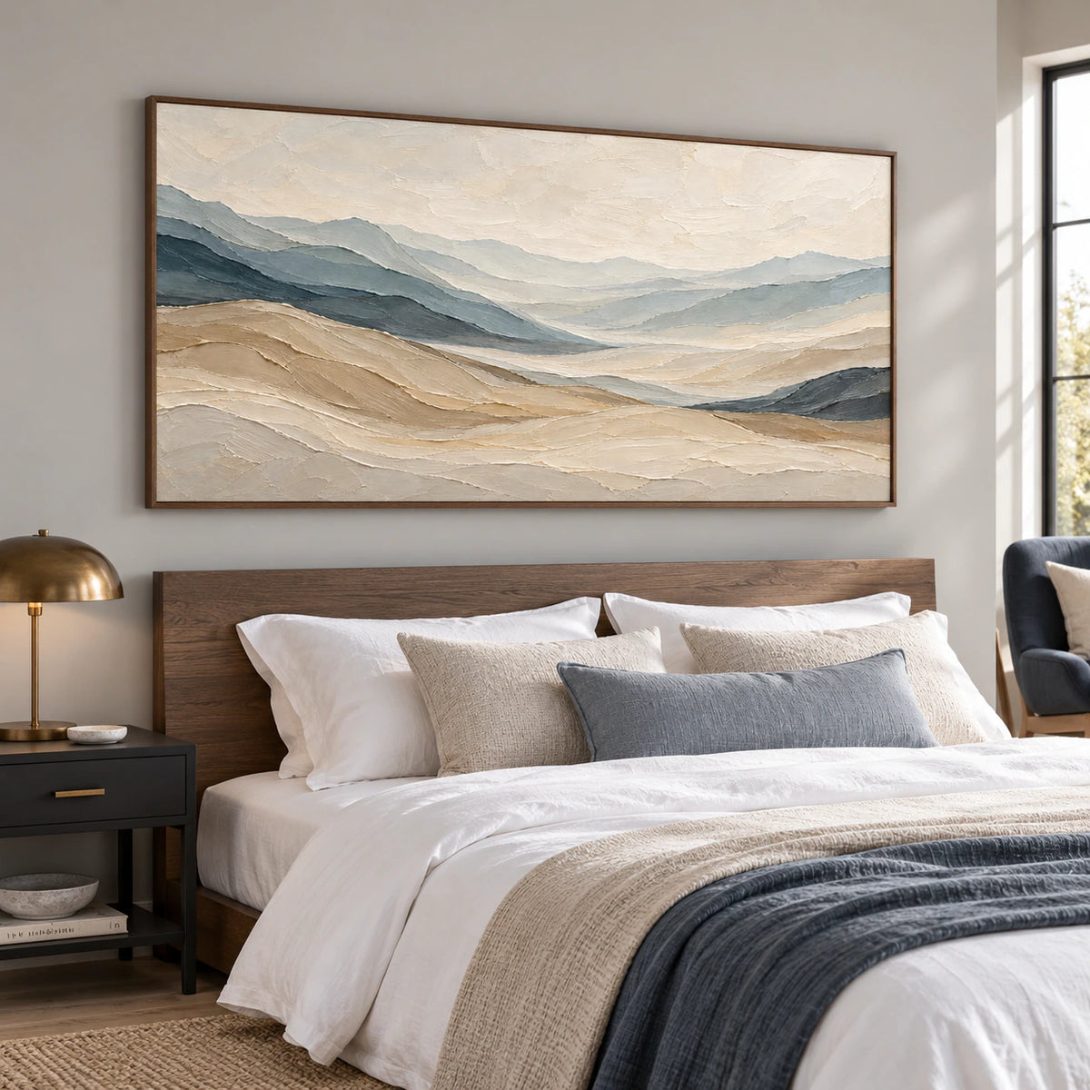 Ochre-Traverse above a low smoked oak headboard against a soft gray wall, with white bedding and a black bedside table, viewed from the left in morning light.