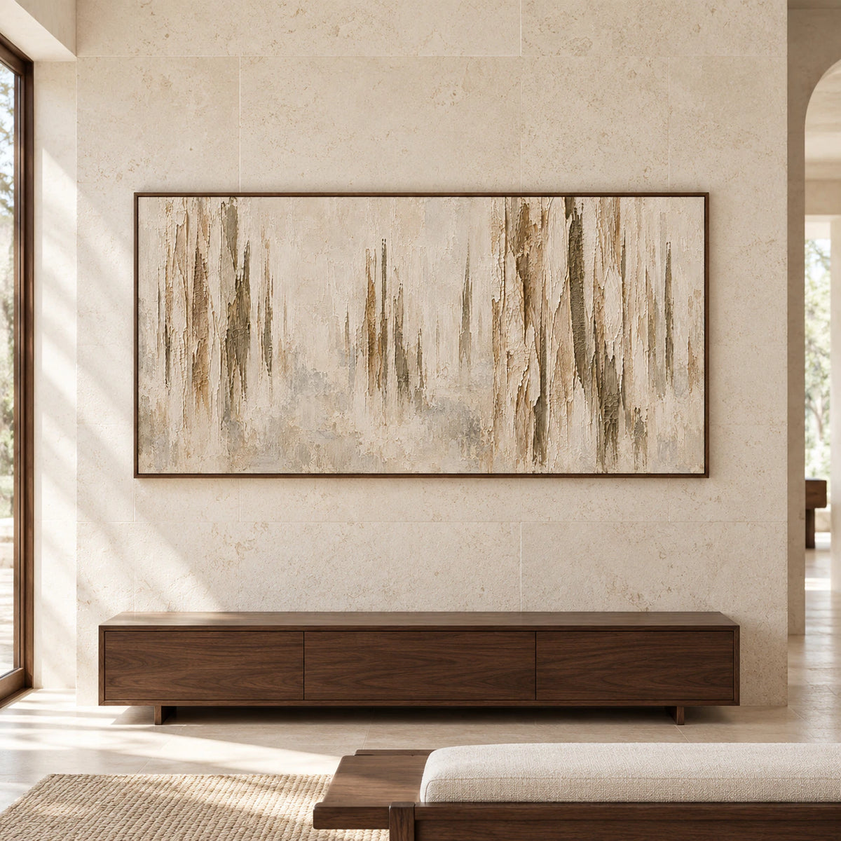 Large abstract painting with vertical ridges and peeling ivory, sand and ochre texture displayed above a low bench in a spacious, light-filled room.