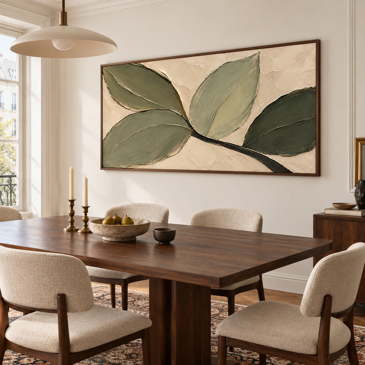 Olive leaf abstract painting commanding a pale plaster wall in a refined dining room, with a dark wood table and restrained neutral chairs.