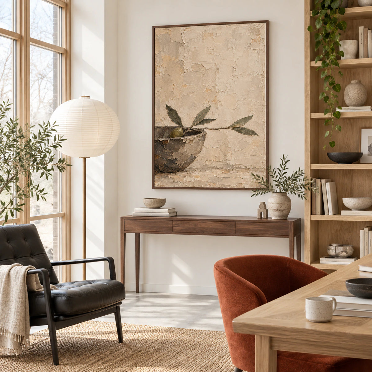 Olive branch wall art in an airy reading and home office space.
