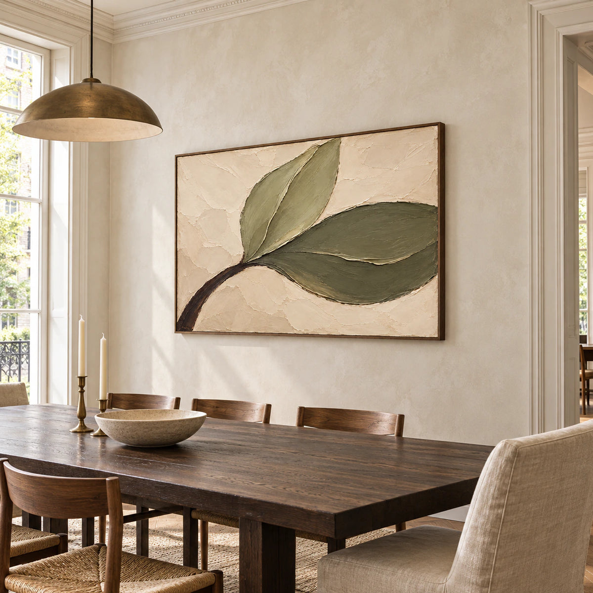 Olive-Sweep painting on a pale limewashed wall above a long dark timber dining table, with slender chairs and a pendant, viewed from the right.