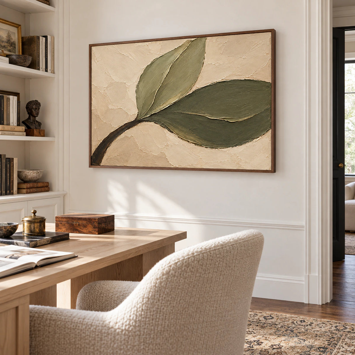 Olive-Sweep painting above a pale desk beside open shelves and a neutral chair in a bright home office, viewed obliquely from the right.