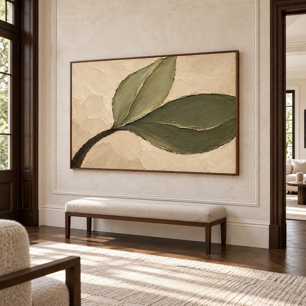 Large Olive-Sweep painting on a tall light stone wall in a bright foyer with a slim bench and an adjoining space visible, viewed from farther back on the left.