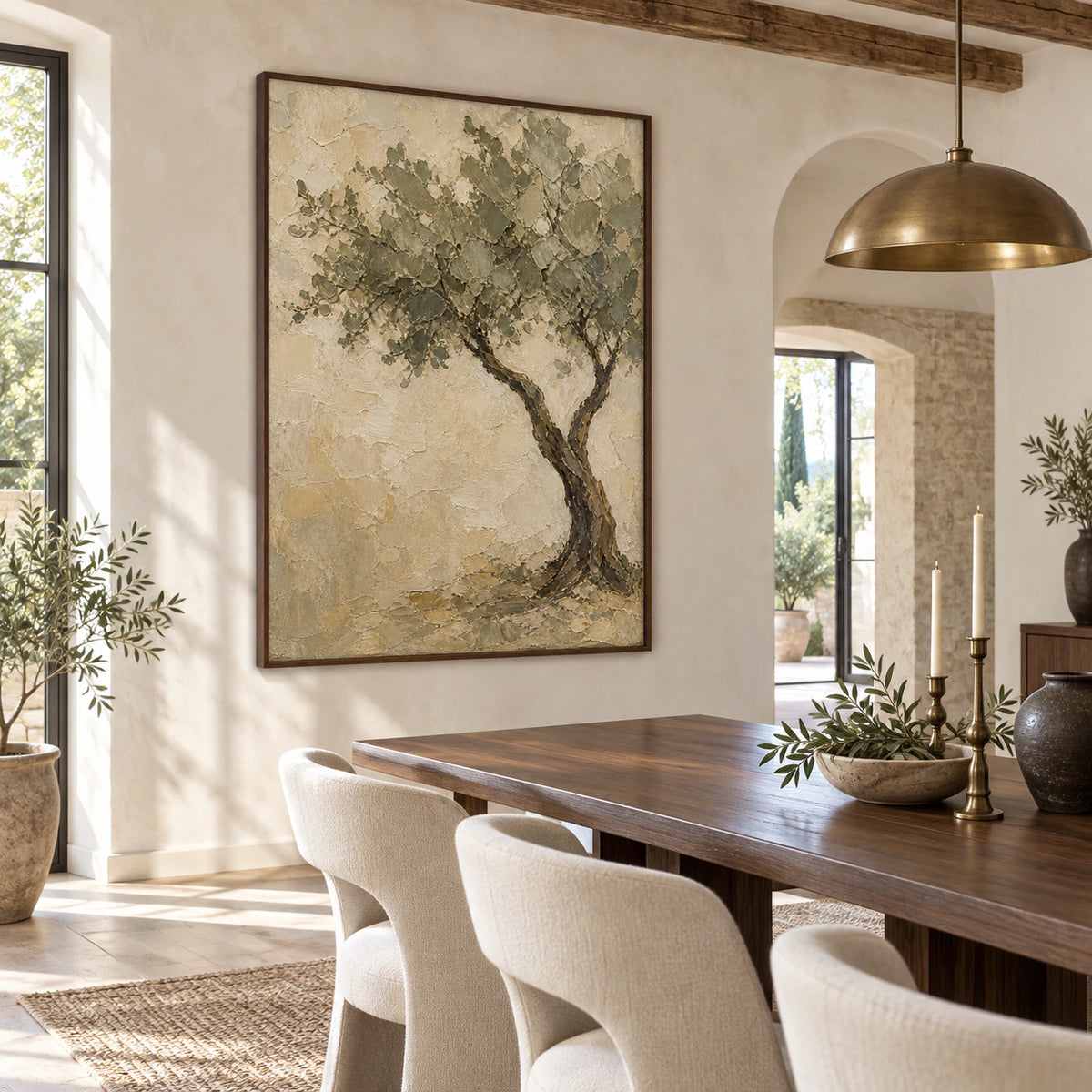 Textured olive tree painting above a refined dining setting in natural daylight.