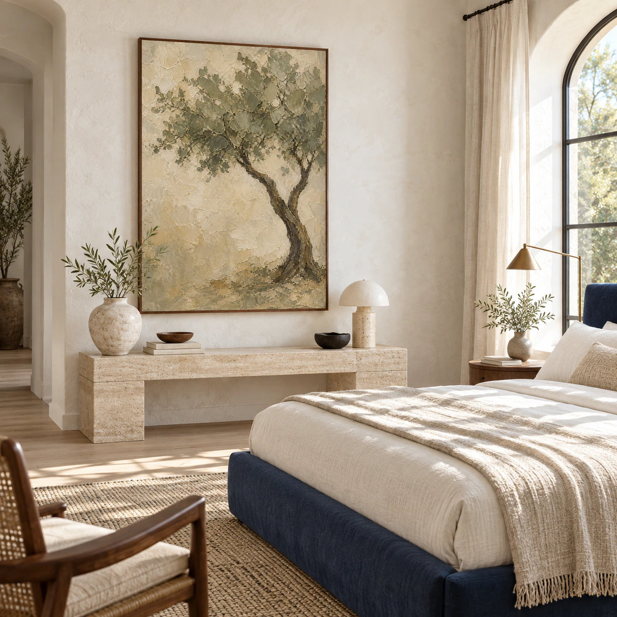 Textured olive tree painting anchoring a quiet, softly lit bedroom.