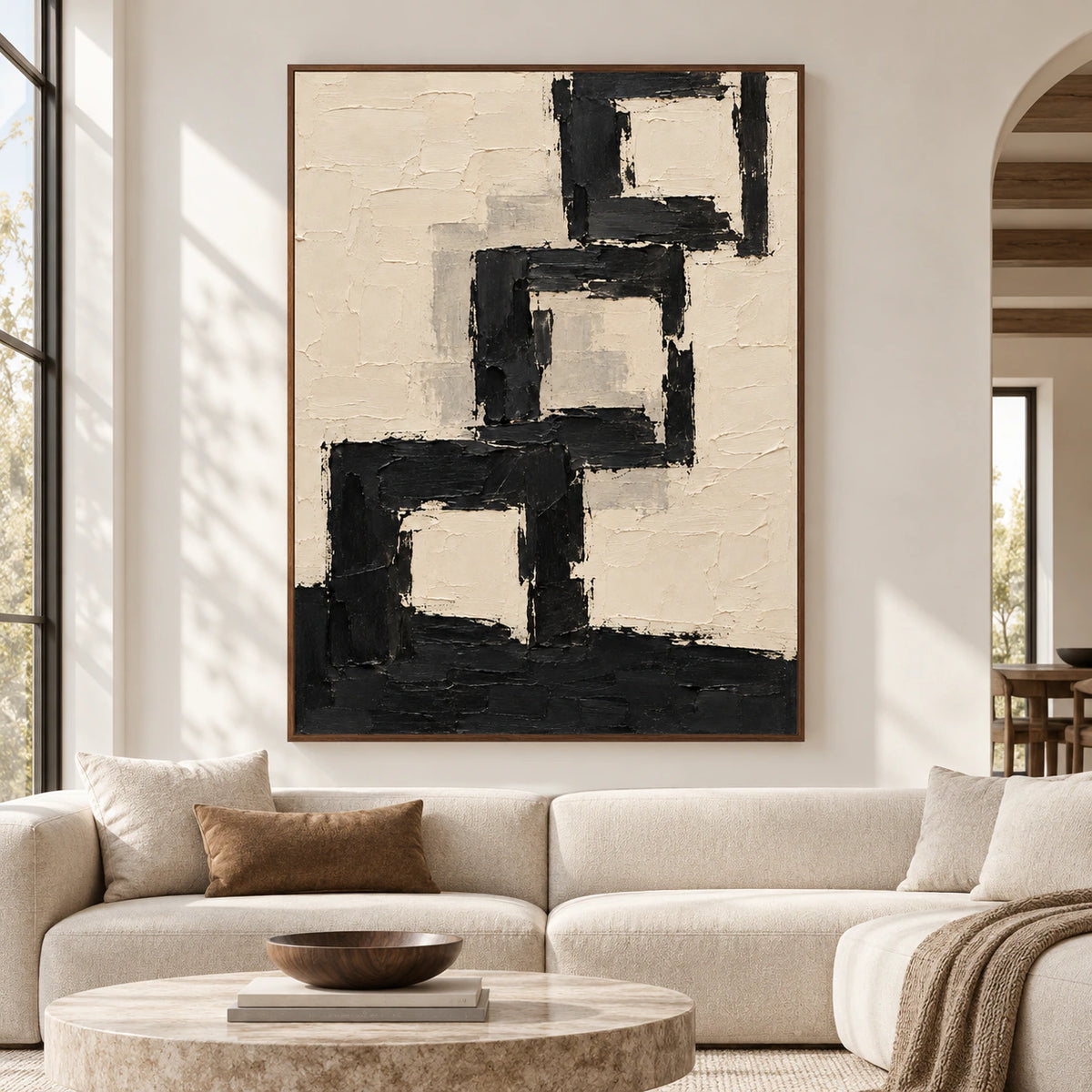 Large Onyx Arcade painting displayed straight-on in a spacious, sunlit room, its vertical black and ivory composition prominent on a pale wall.
