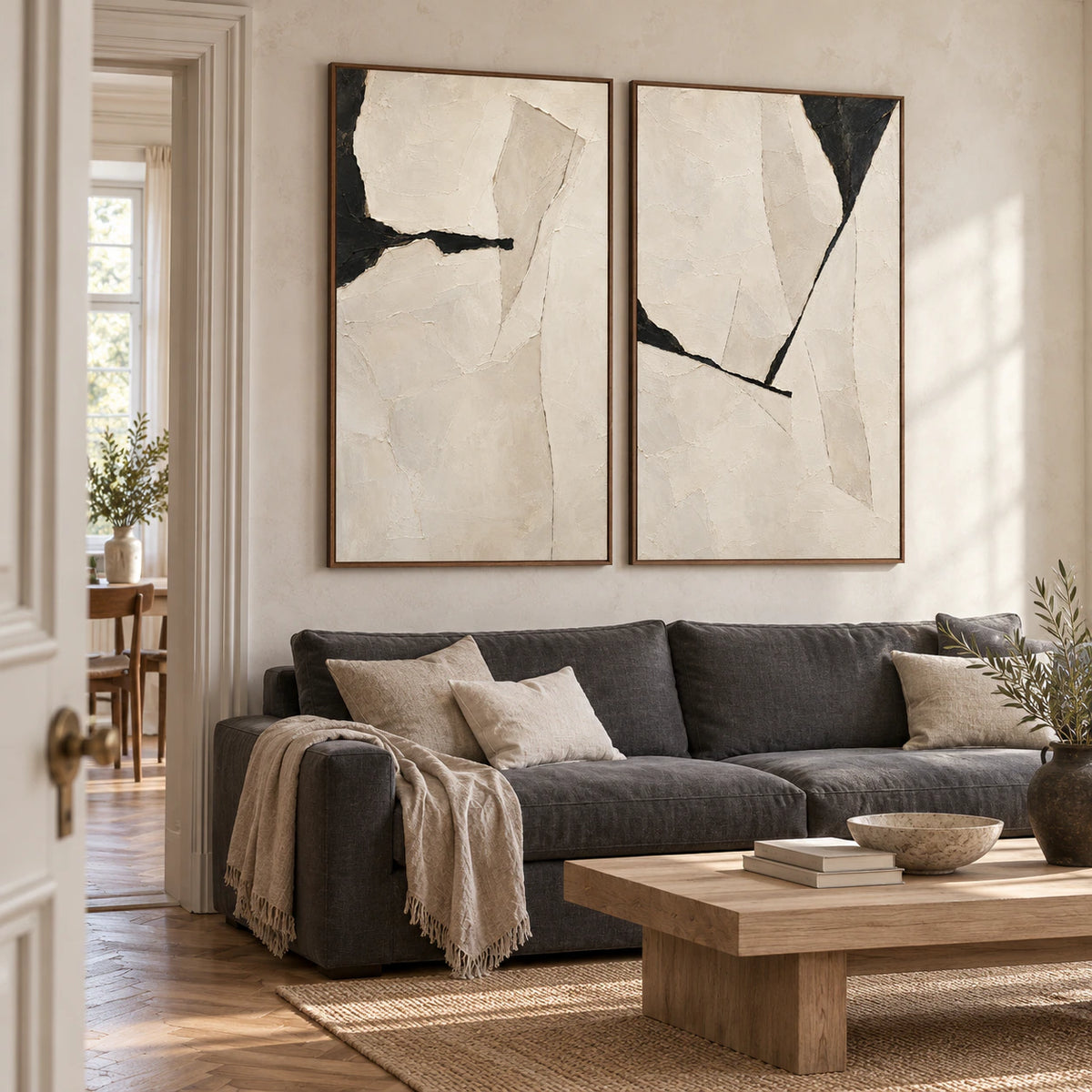 Bright living room with the Onyx-Rupture two-canvas diptych displayed side by side.