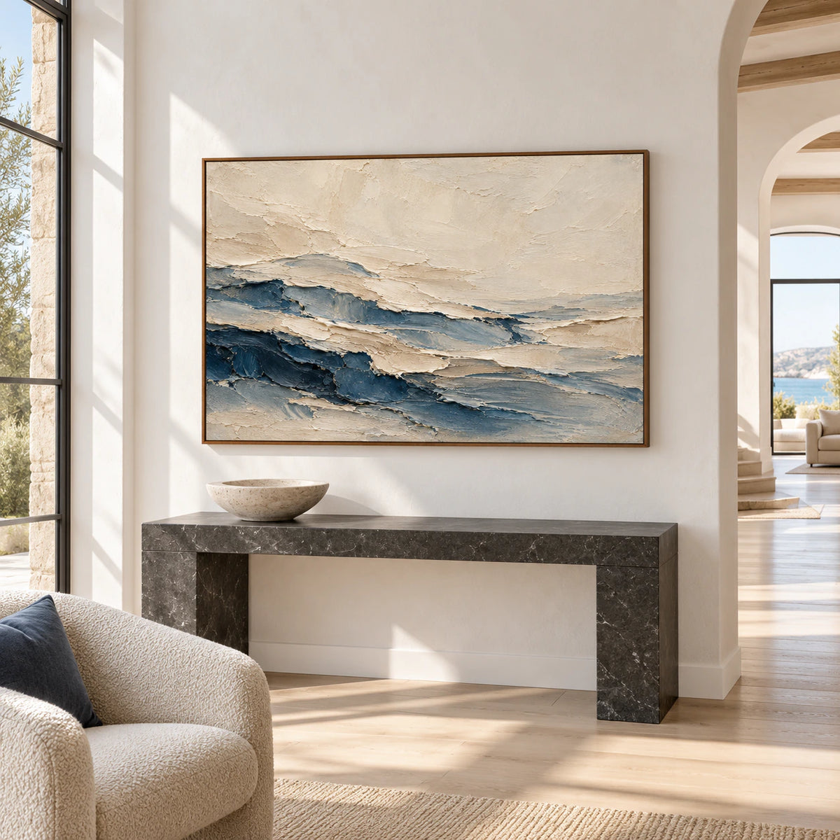 Large cream and blue abstract painting on a high pale foyer wall, viewed from a low left angle with a dark stone console and sculptural object.