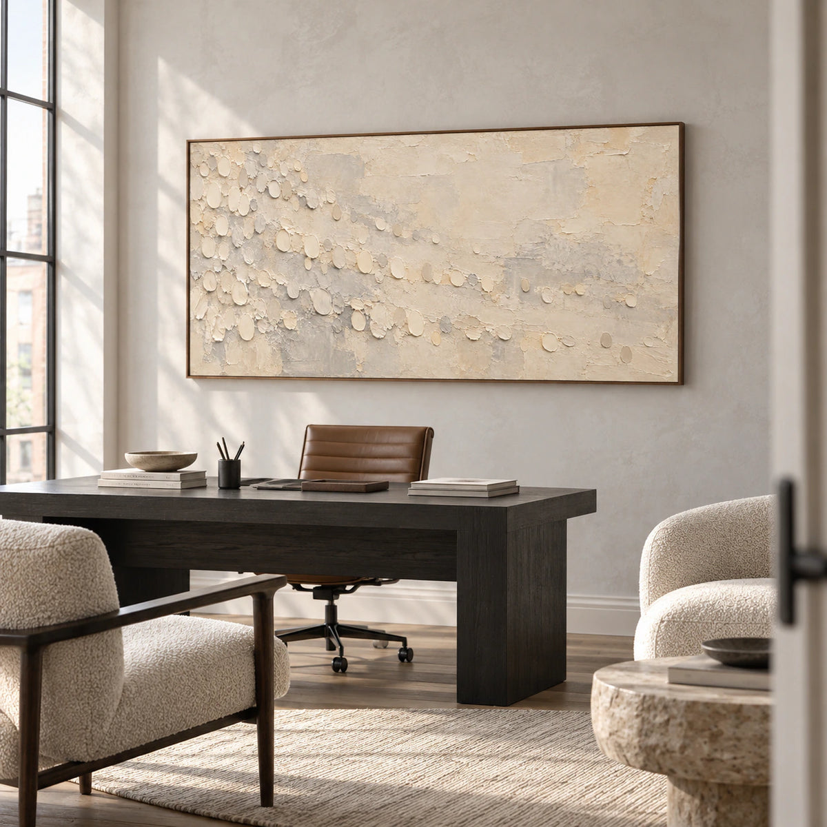 Pale-Drift shown prominently on a light plaster wall in an airy home office with a dark desk and open daylight.