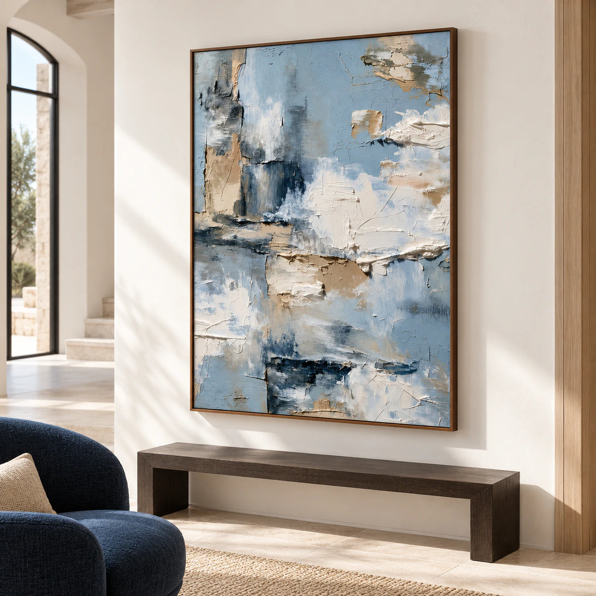 Large vertical abstract painting commanding a bright foyer with a stone floor, open architectural volume and a simple dark bench.