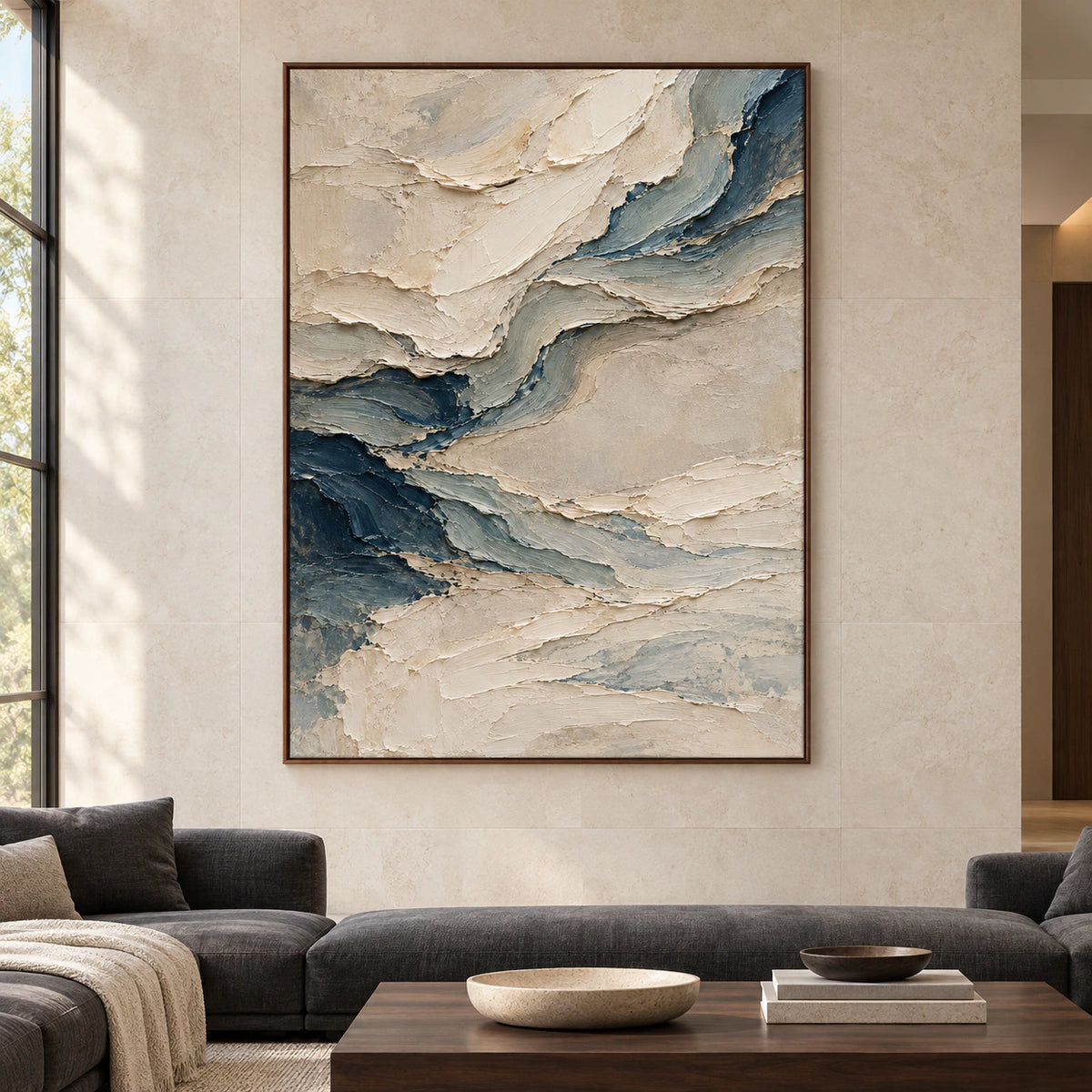 Pale-Undertow displayed at large scale in a straight-on view of a bright living room with pale limestone walls, charcoal seating and dark wood details.