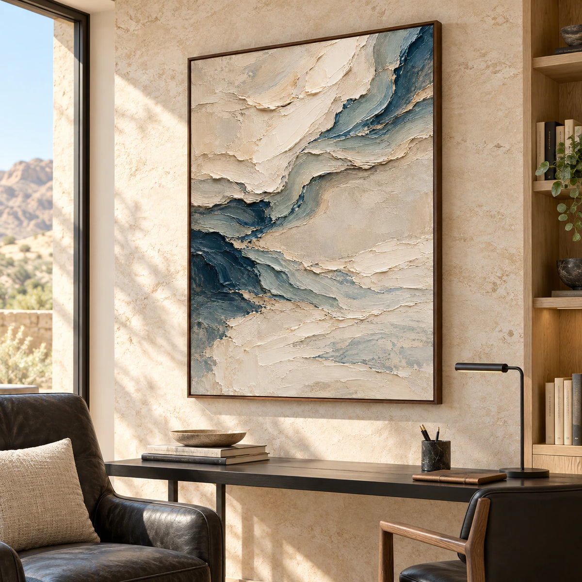 Pale-Undertow above a slim black desk, viewed from the left in a bright home office with a pale oak bookcase and dark leather reading chair.