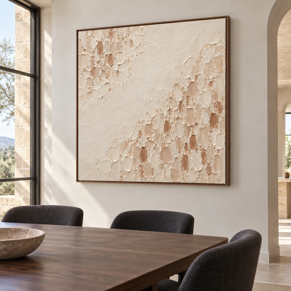 Square Parchment-Divide painting on a cool pale wall above a dark walnut dining table with dark charcoal upholstered chairs, viewed slightly from the left.