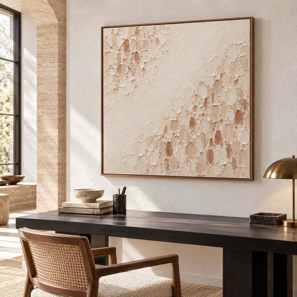 Square Parchment-Divide painting above a black desk against a pale cool wall, with a slim reading chair, viewed from a high position on the left.