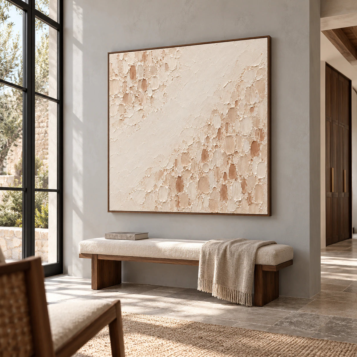 Large square Parchment-Divide painting on a cool gray foyer wall, with a stone floor, bench and tall side windows, viewed from a low angle on the right.