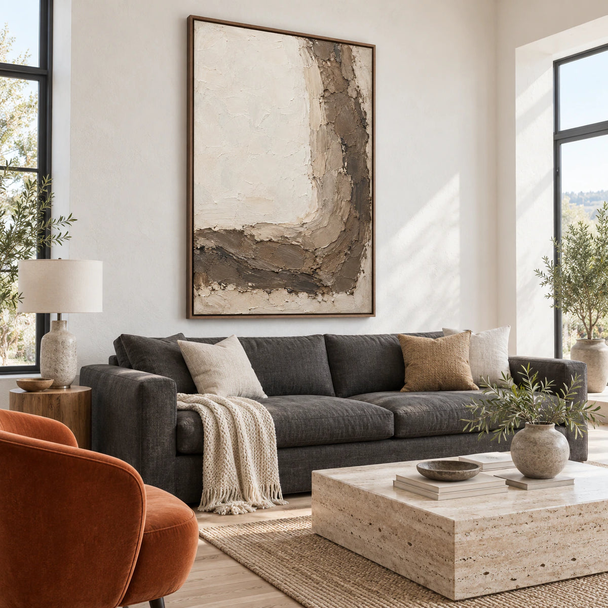 Vertical ivory and earth-toned textured abstract painting as the focal point of a bright living room.