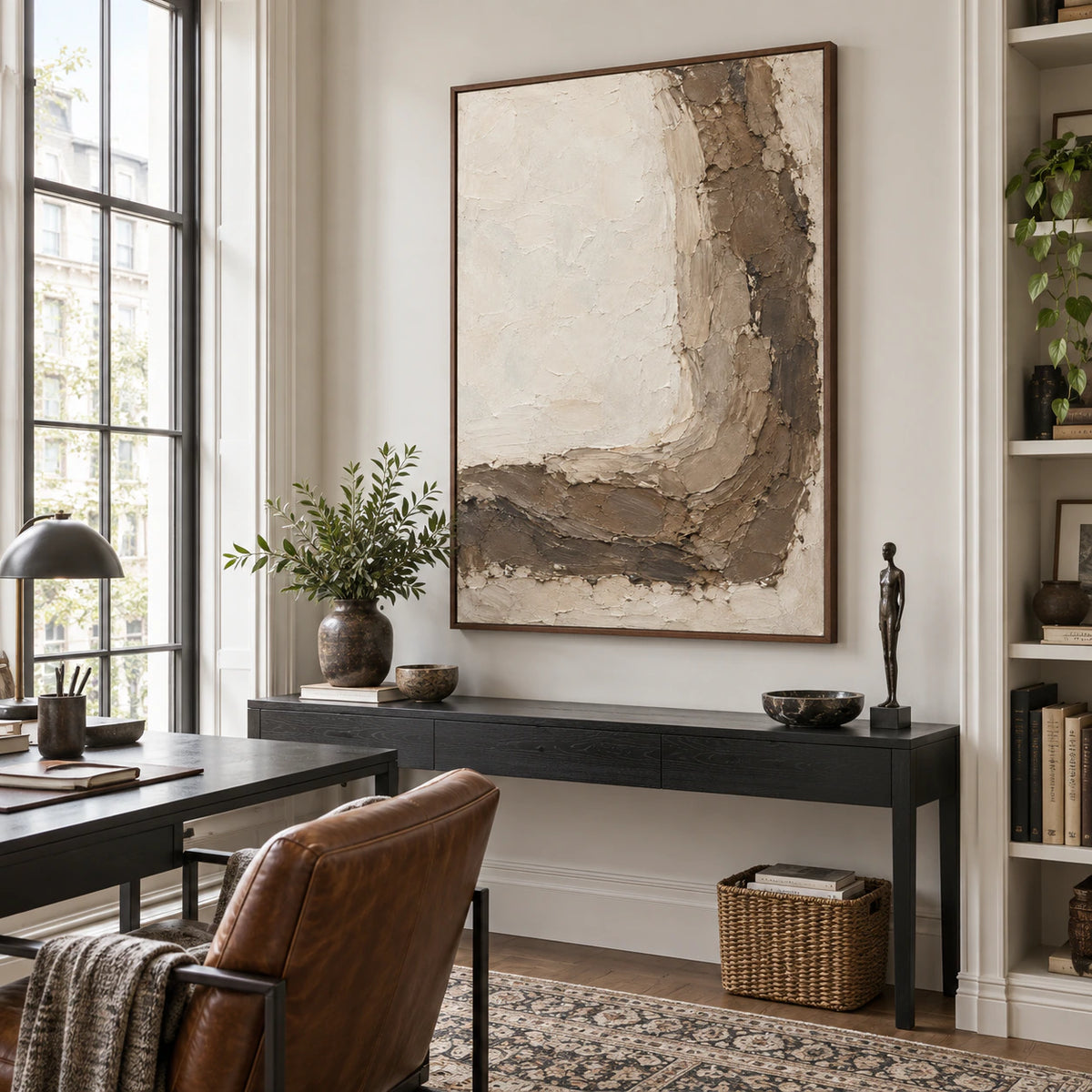 Vertical ivory and earth-toned textured abstract painting in an airy reading office.