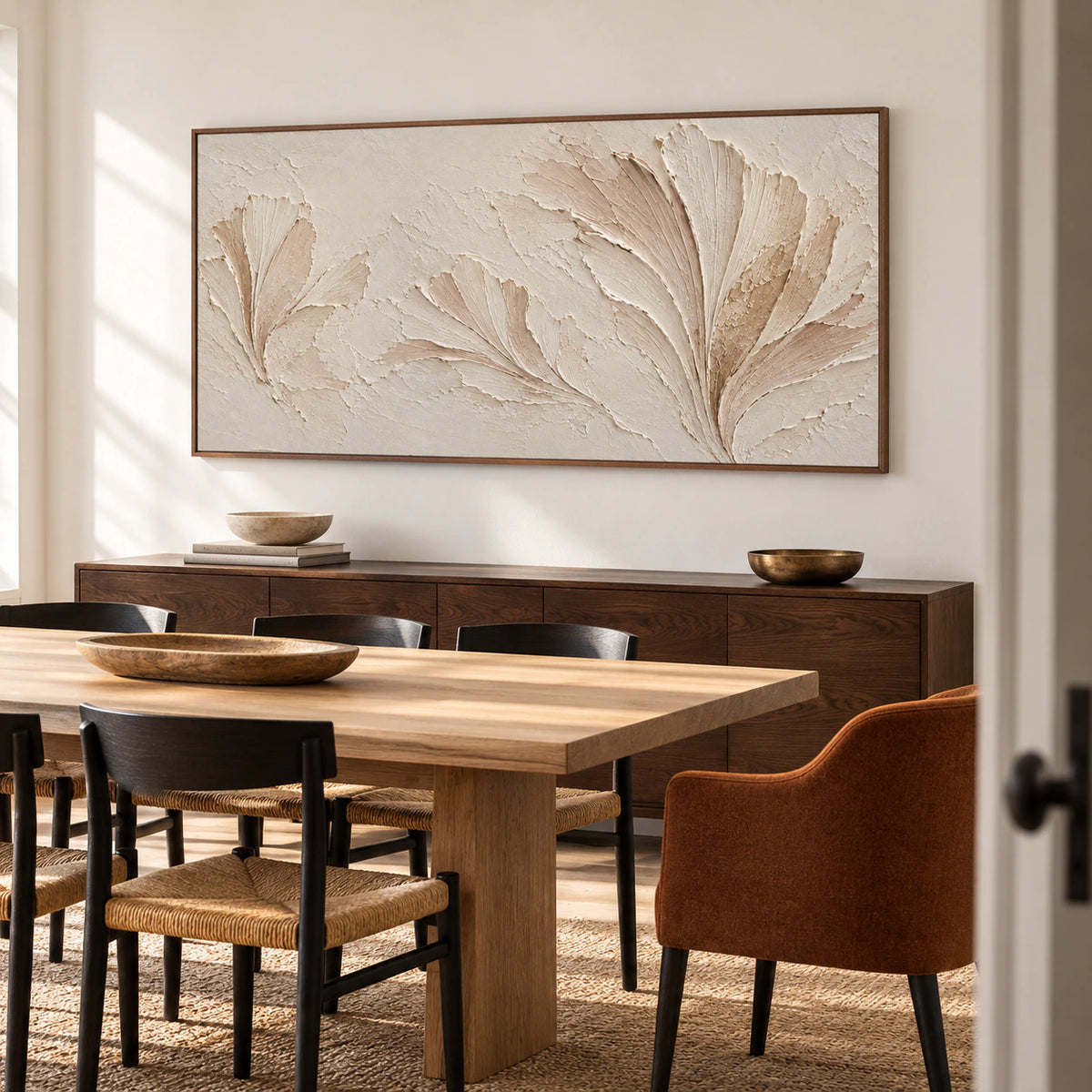 Parchment Fronds anchors a refined dining room, hung above a dark wood sideboard beside a long table and restrained black chairs.