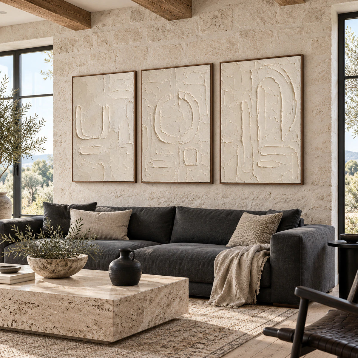 Parchment-Glyph triptych above a sofa in a bright contemporary living room.