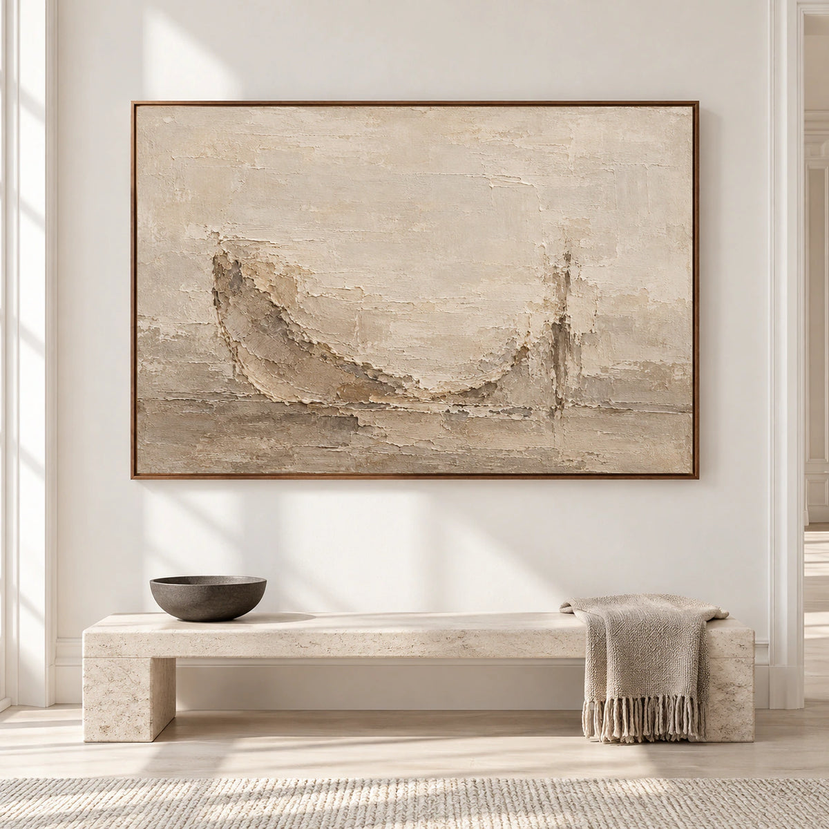 Large horizontal parchment-toned abstract painting with raised weathered ridges displayed on a wall in a spacious, sunlit room.