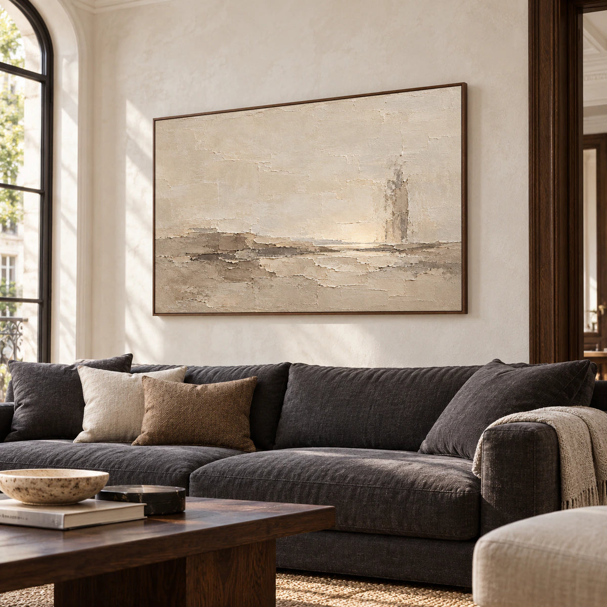 Parchment-Shoal above a restrained charcoal sofa in a bright living room.