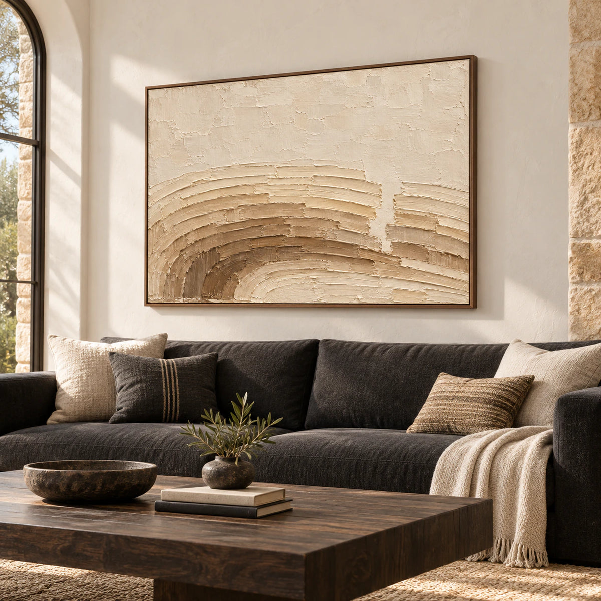 Parchment-Swerve hangs above a charcoal sofa in a bright living room with pale walls and natural daylight.
