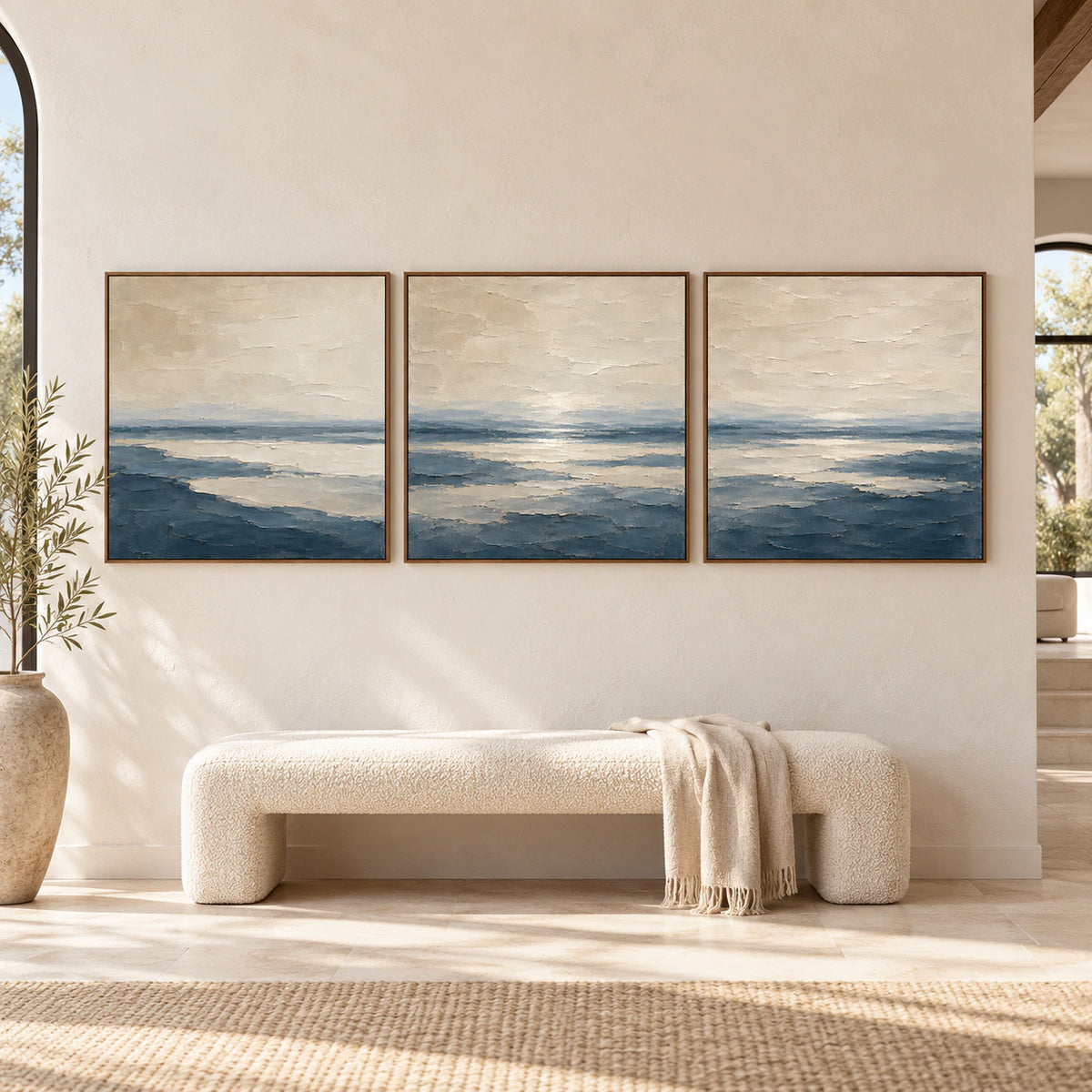 Large straight-on interior view of the Pelagic-Quiet three-canvas triptych in slim walnut frames.