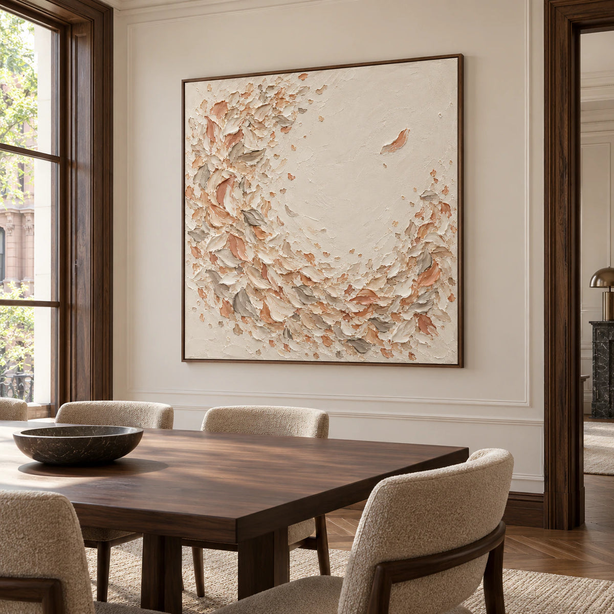 Square abstract painting displayed above a long dark wood dining table in a refined, daylight-filled dining room with sculptural chairs.