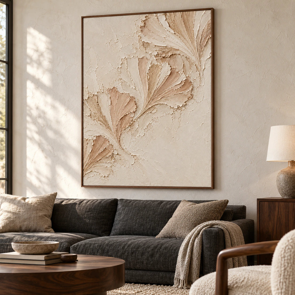 Petal-Folds on a light plaster wall above a charcoal linen sofa beside a dark wood side table, viewed from the left in natural daylight.