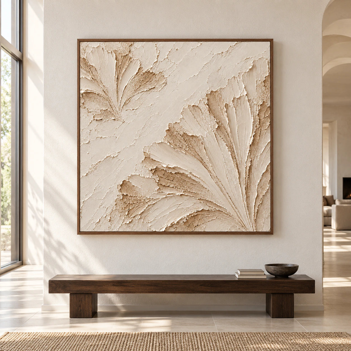 Large square artwork with ivory and sand-toned raised arcs, centered on a pale wall in a spacious, sunlit room.
