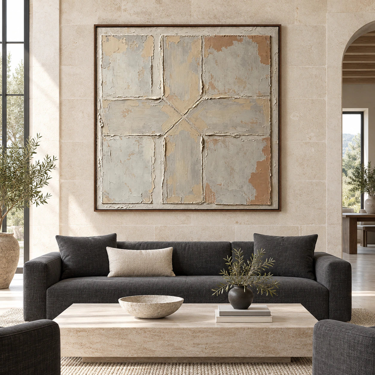 Large square textured abstract artwork in a bright architectural living space.