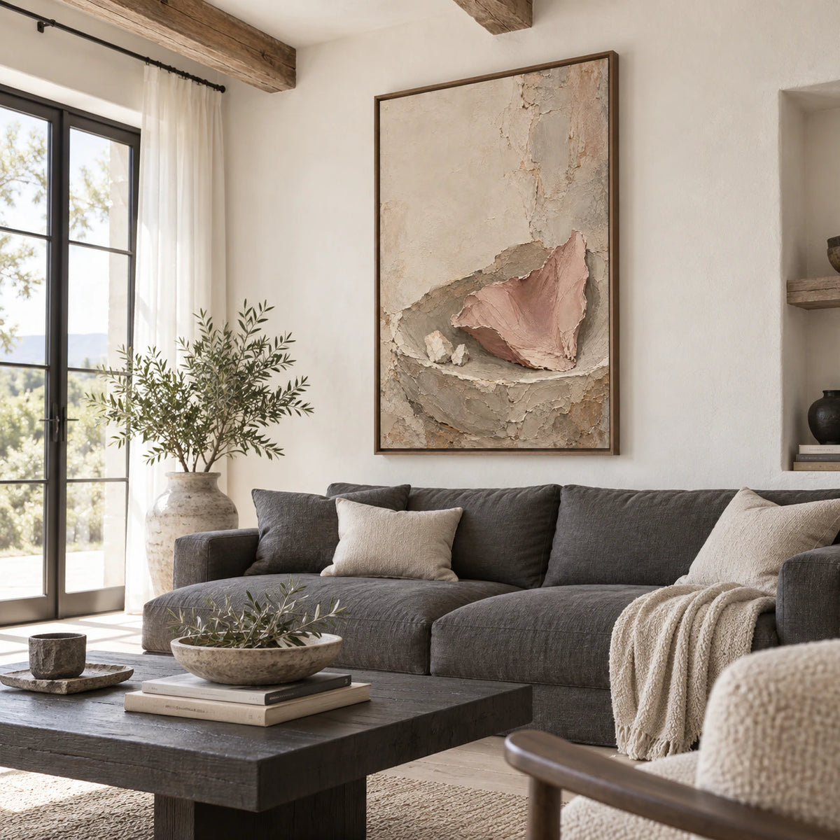 Large Plaster-Ember artwork above a pale neutral sofa in a bright living room.