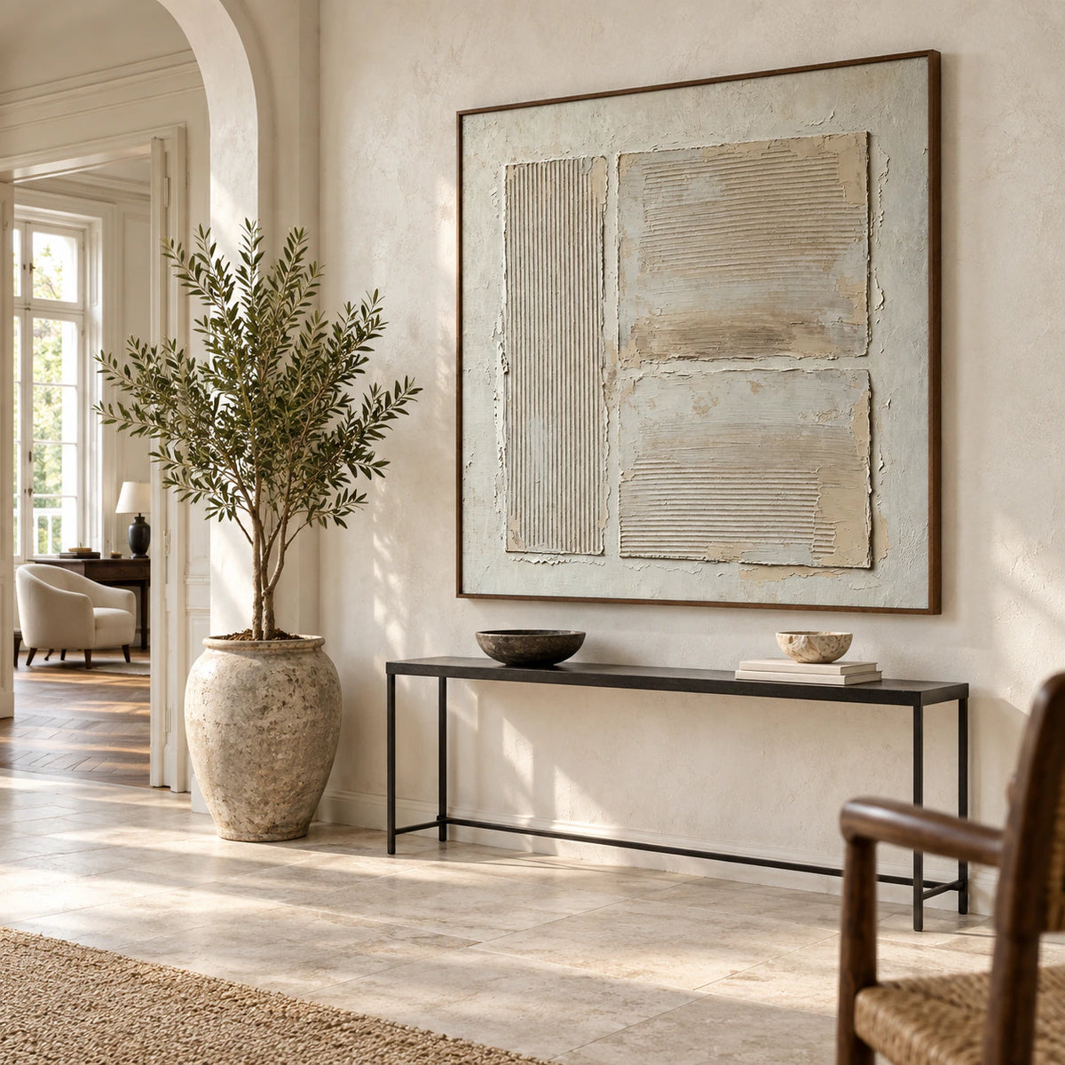 Large square textured artwork anchoring a gallery-scale foyer.