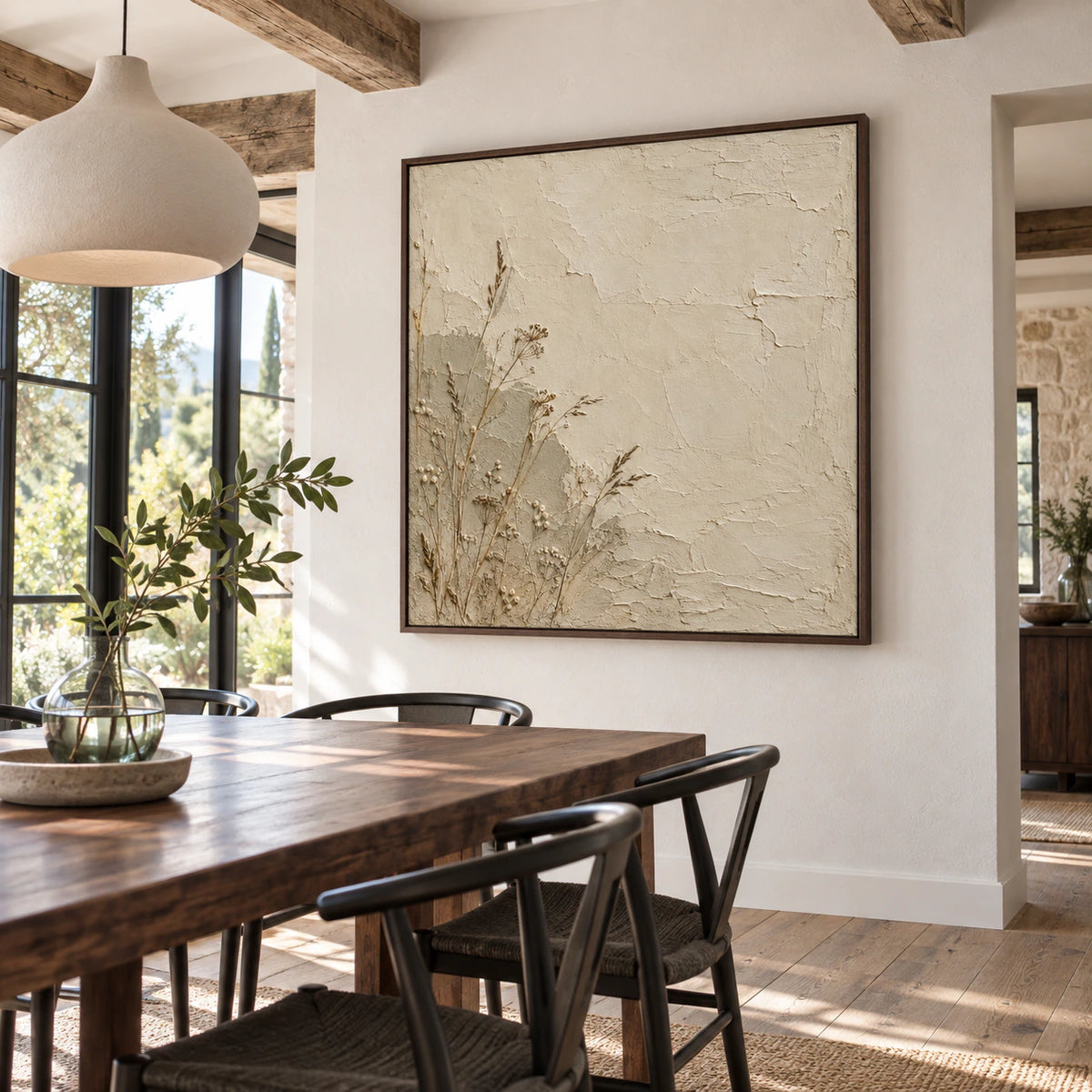 Square textured botanical artwork in a refined daylight dining room.