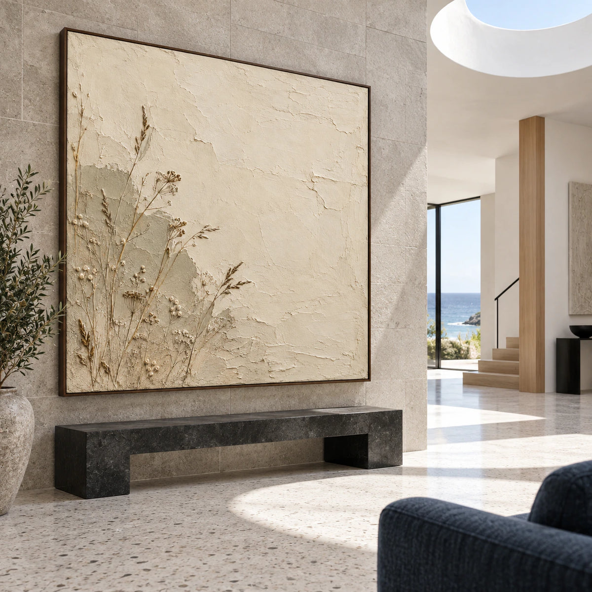 Large square botanical plaster artwork in a gallery-scale stone foyer.