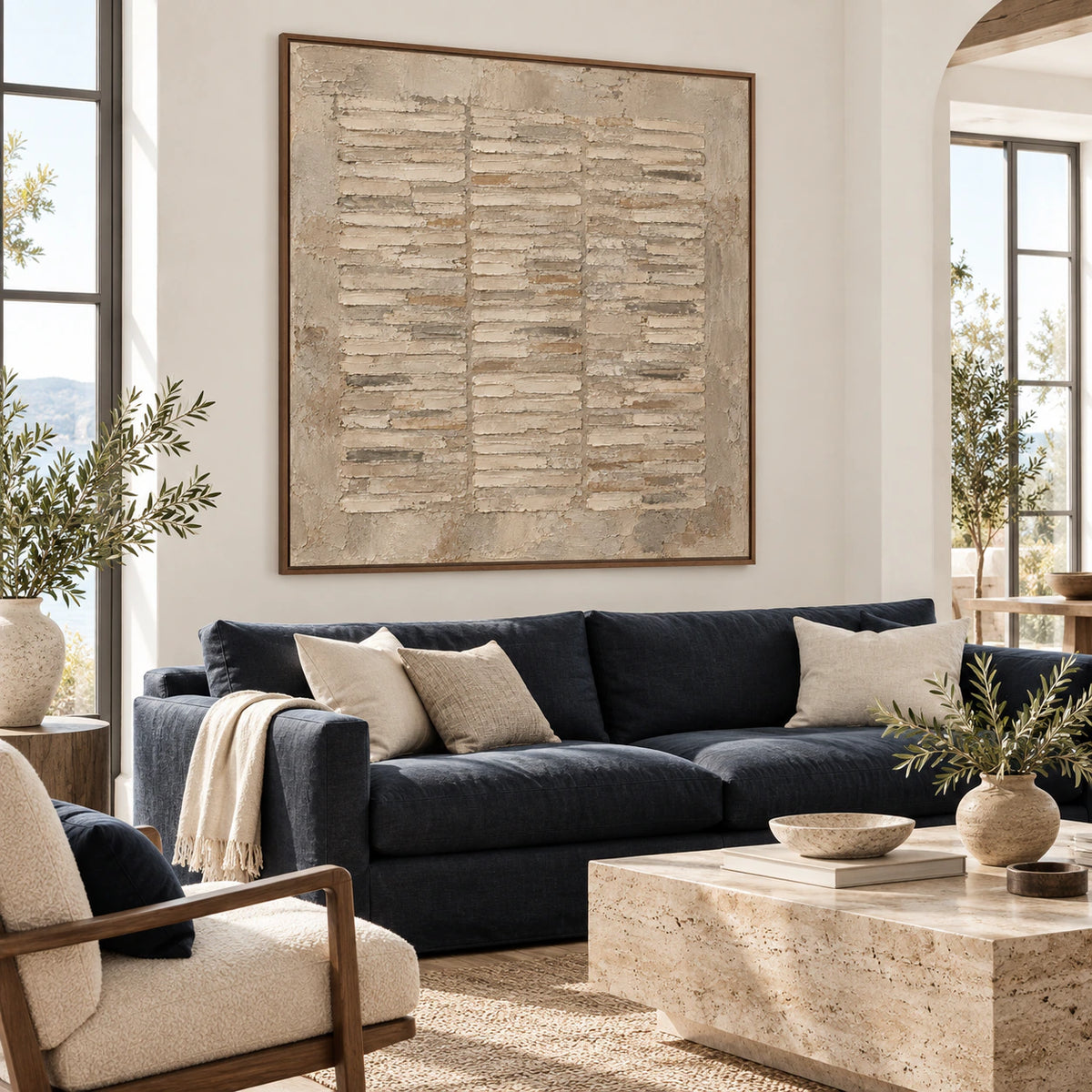 Square textured abstract painting above a sofa in a bright living room.