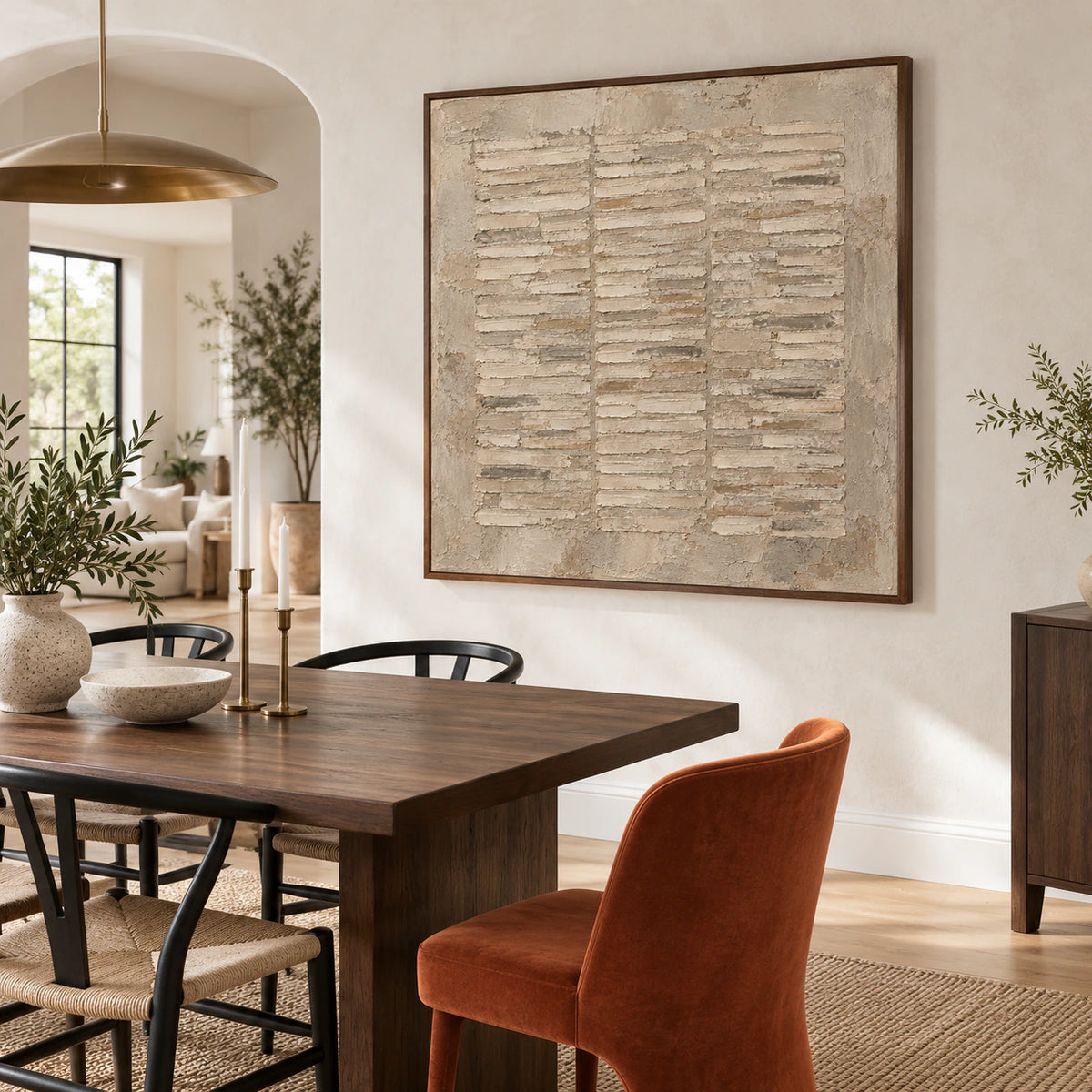 Square textured abstract painting in a refined daylight dining room.