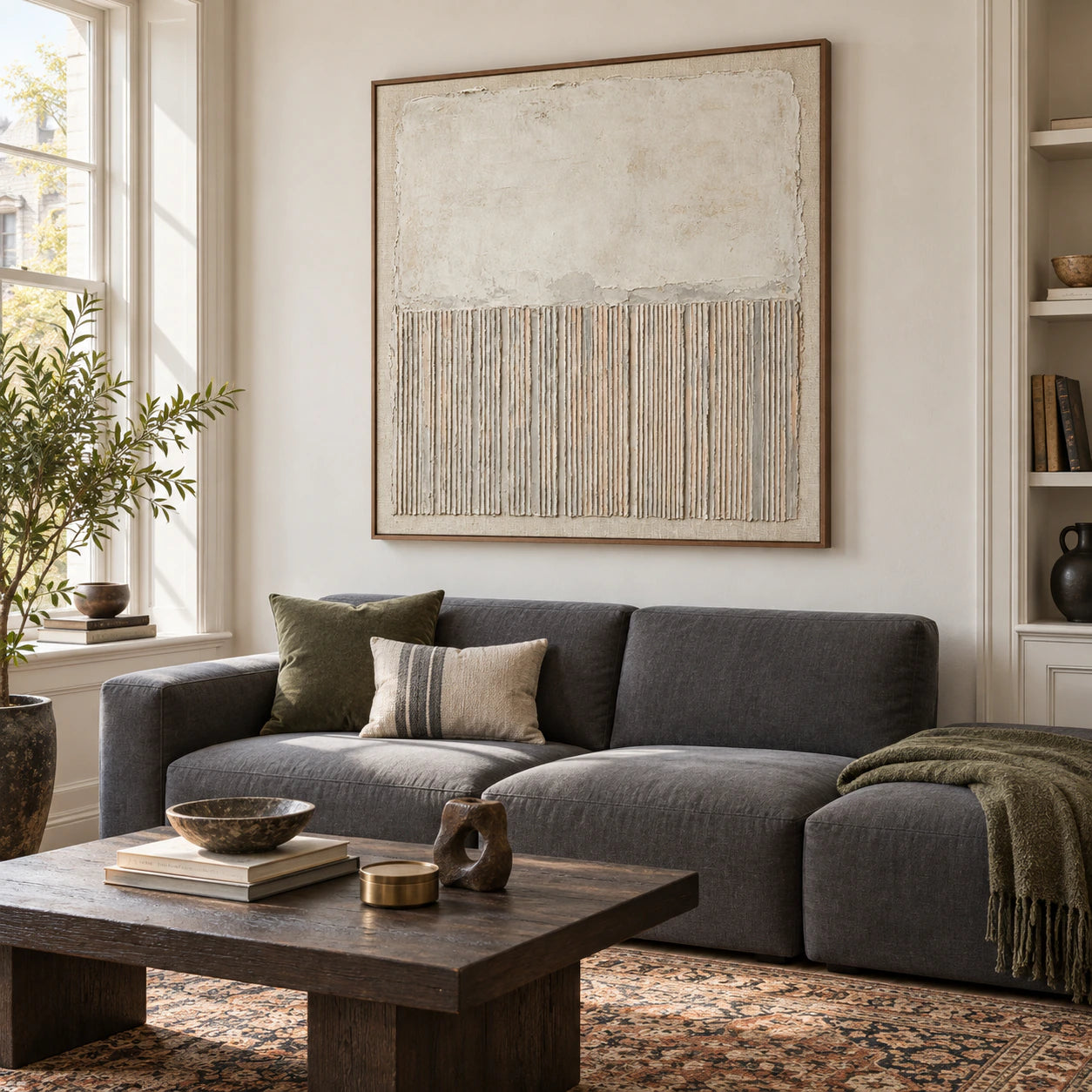 Square ivory textured abstract painting above a sofa in a bright living room.