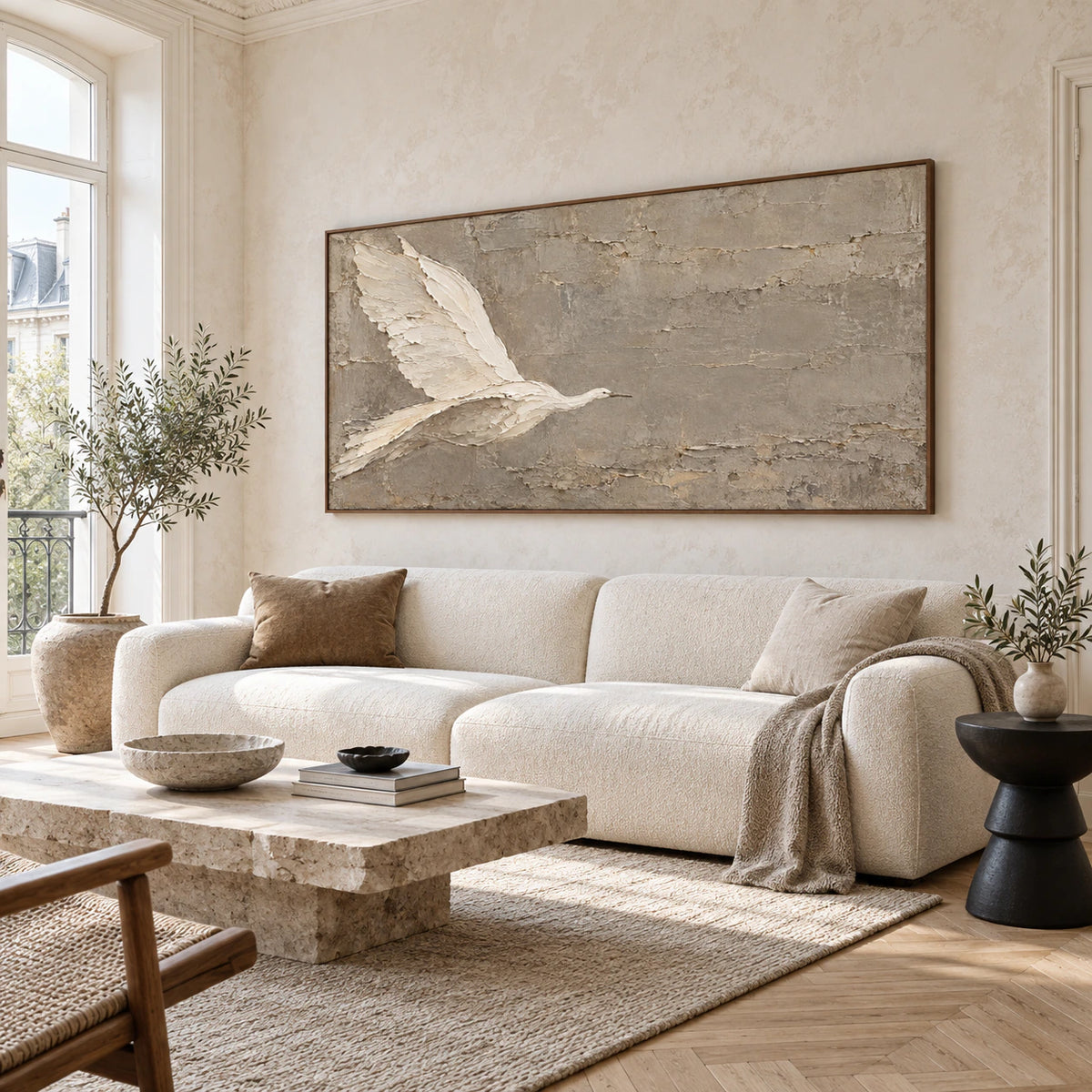 Textured bird artwork above a sofa in a bright contemporary living room