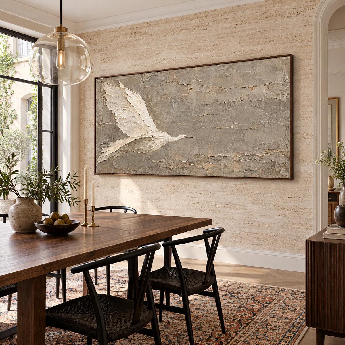 Large neutral bird artwork in a refined daylight-filled dining room