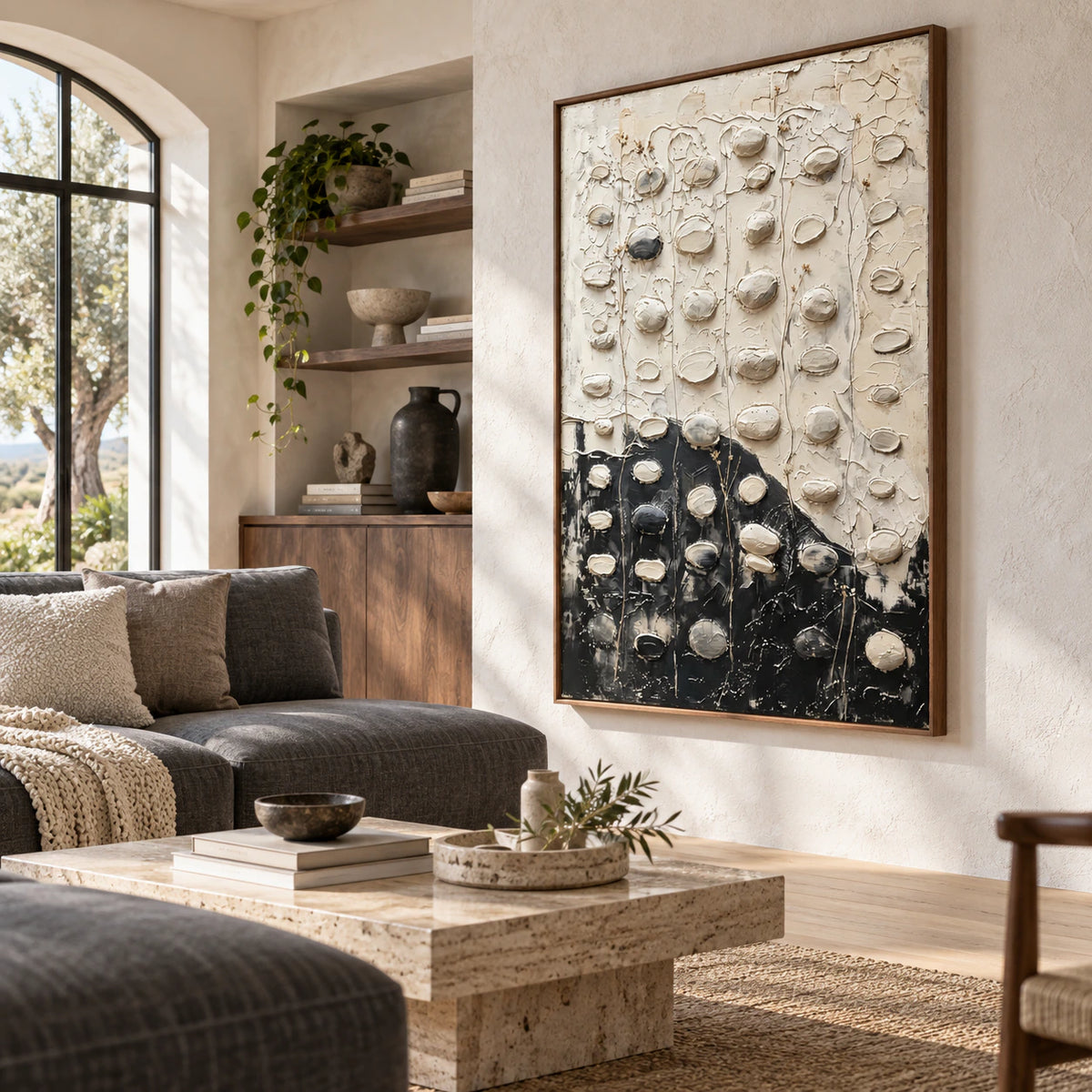 Vertical textured abstract painting above a neutral sofa in a bright living room.