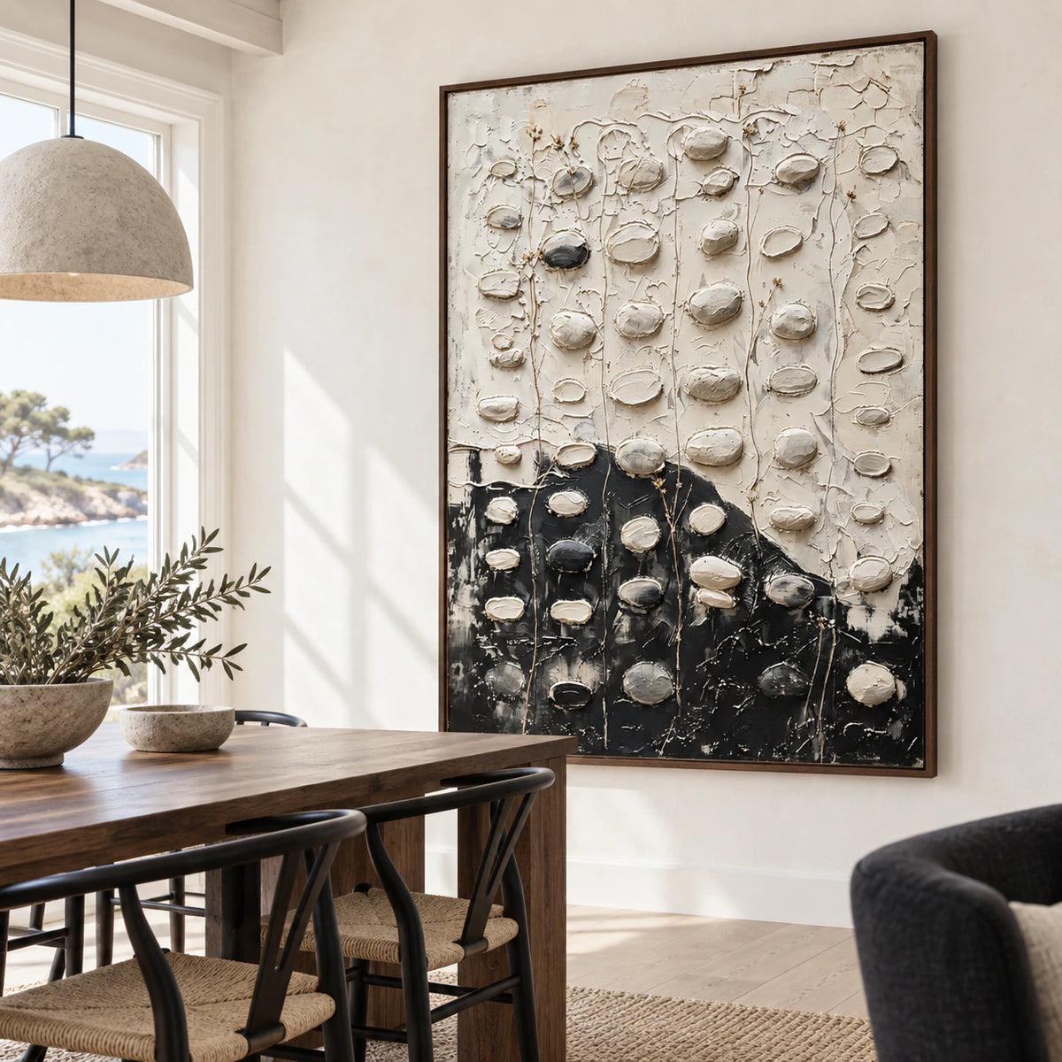 Large black-and-white relief painting in a refined daylight dining room.