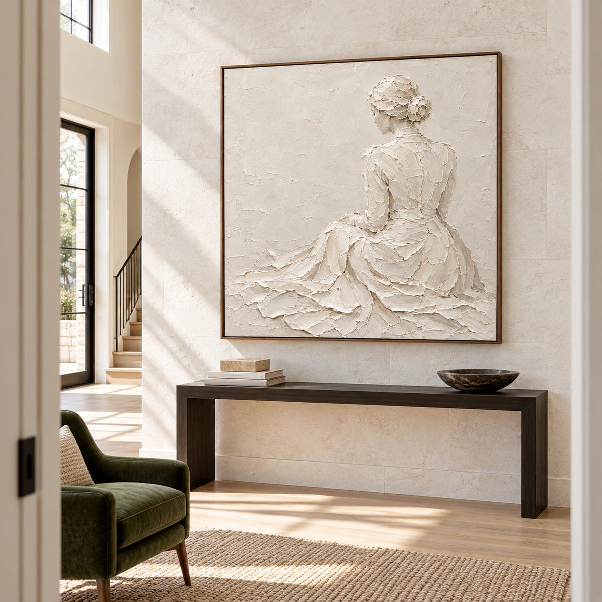Large ivory relief artwork commanding a high-ceiling foyer with pale stone walls, a dark console, and generous daylight.