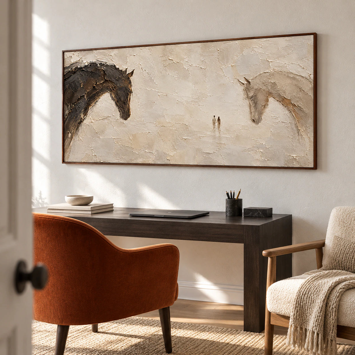 Wide horse painting above a dark desk near a reading chair against a cool-white wall, viewed from a low left angle in a bright home office.
