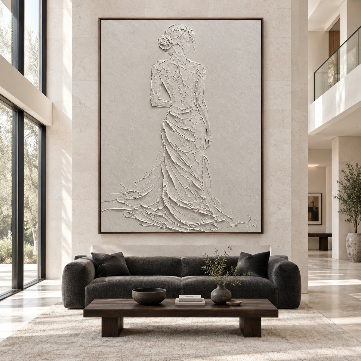 Large ivory relief figure artwork shown straight-on at gallery scale in a bright architectural living space.