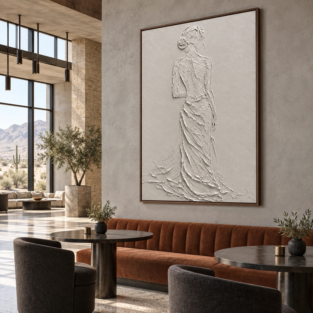 Large ivory relief figure painting featured in an open hospitality loft interior.