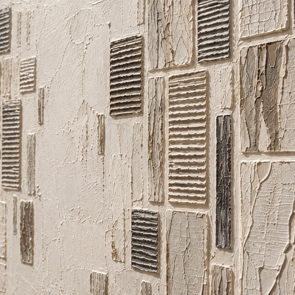 Close oblique detail of Quiet-Facades, showing ivory and charcoal forms, ribbed paint relief and surface texture under grazing directional light.