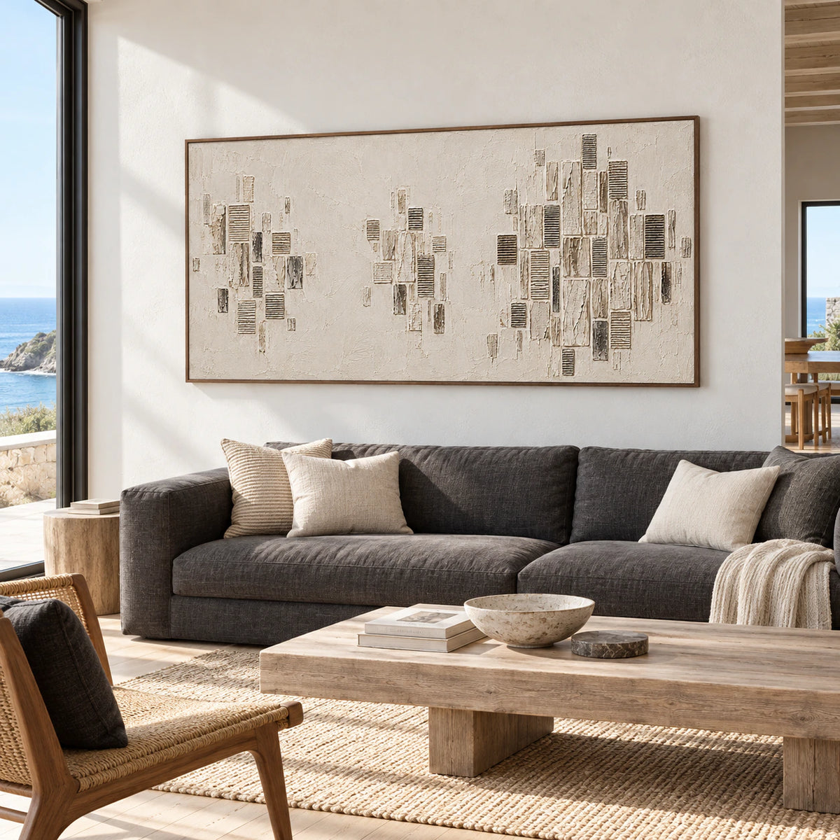 Quiet-Facades above a charcoal sofa in a bright living room with pale walls and restrained contrasting furnishings.