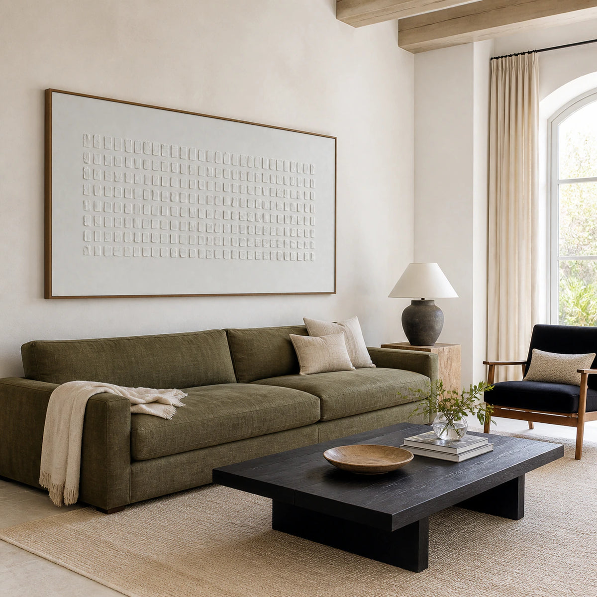 Bright living room featuring the white geometric relief artwork above a restrained sofa.